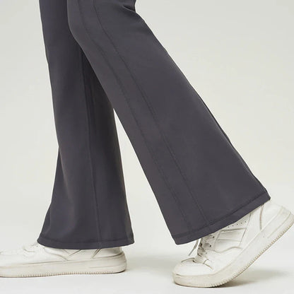 Premium nylon bell-bottom trousers with slimming high-waist design, perfect for Kiwi women's fitness and everyday style.