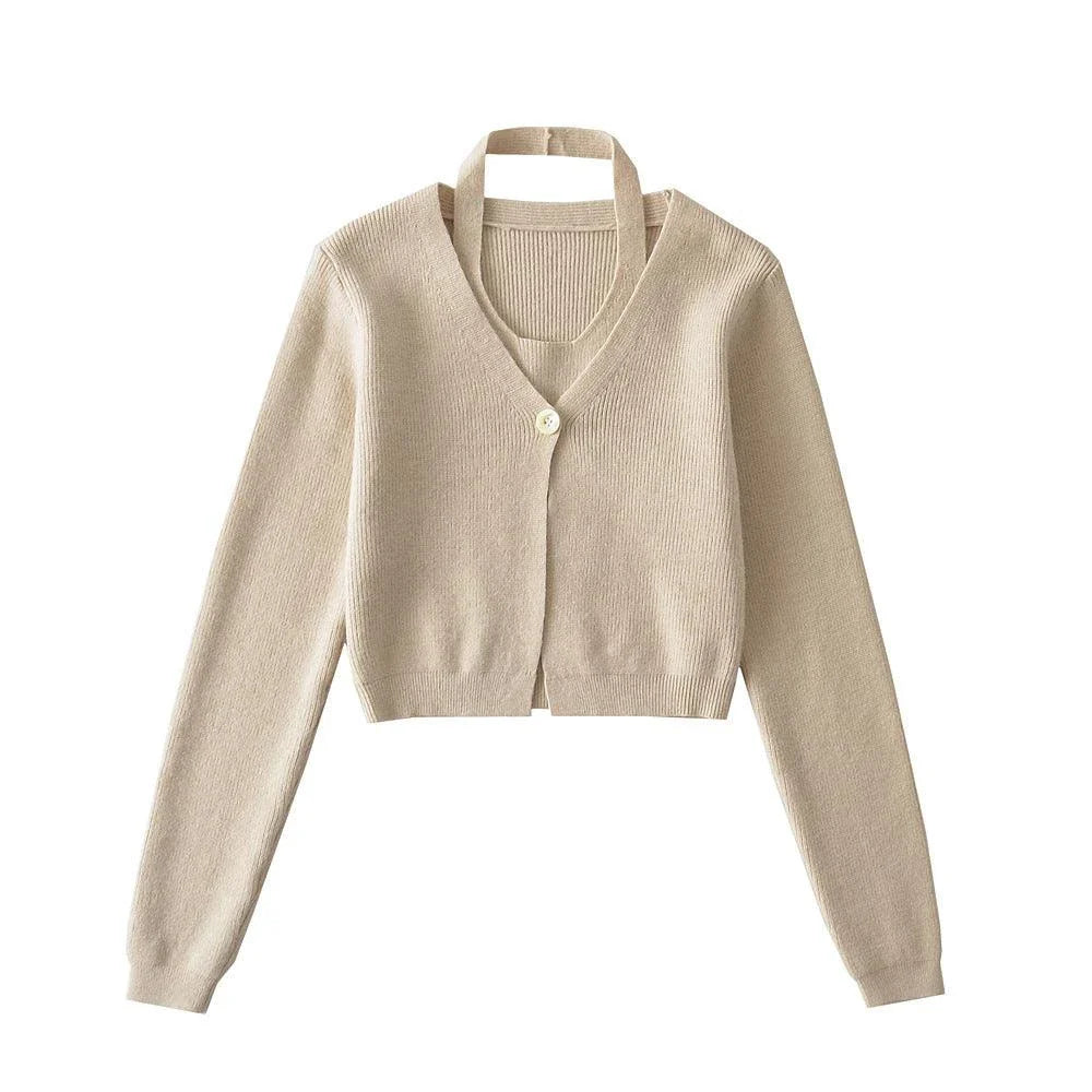 Stylish knitwear vest in a classic black or neutral colour, featuring a V-neck collar and long sleeves for a polished, versatile look.