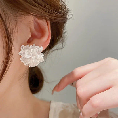 Elegant white floral stud earrings with a timeless design, perfect for adding a touch of sophistication to any Kiwi outfit.