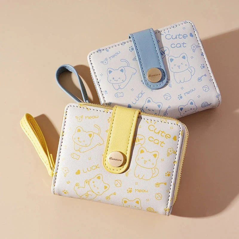 A stylish compact wallet featuring a playful cat-themed design with a tilted head motif, available in a range of candy-inspired colours.