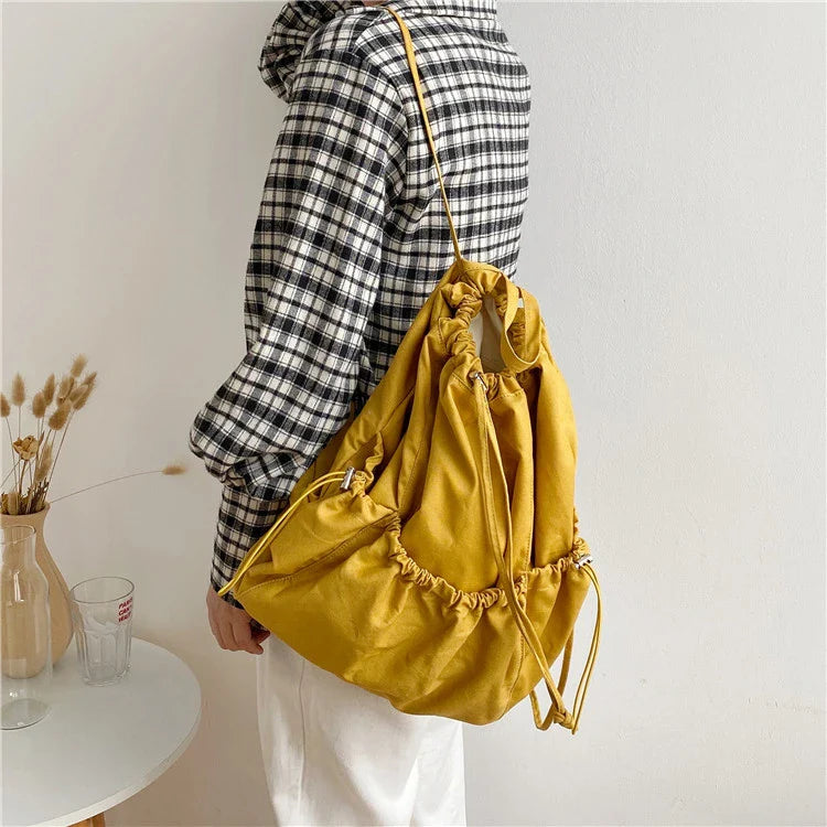 A stylish drawstring bucket bag made of premium polyester fabric, available in a variety of on-trend colours to complement your New Zealand fashion