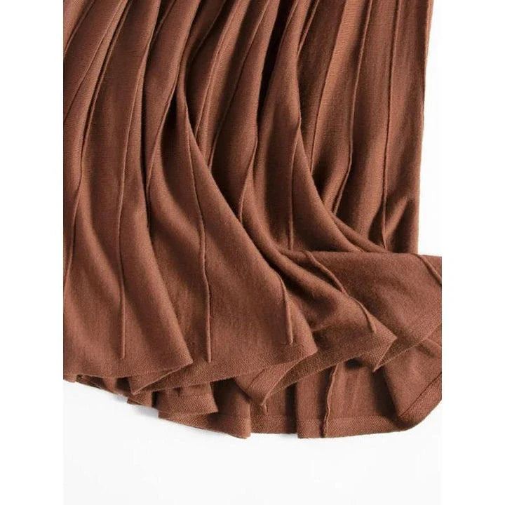 A stylish and versatile mid-calf pleated wool skirt in a chocolate color, perfect for the chilly seasons.