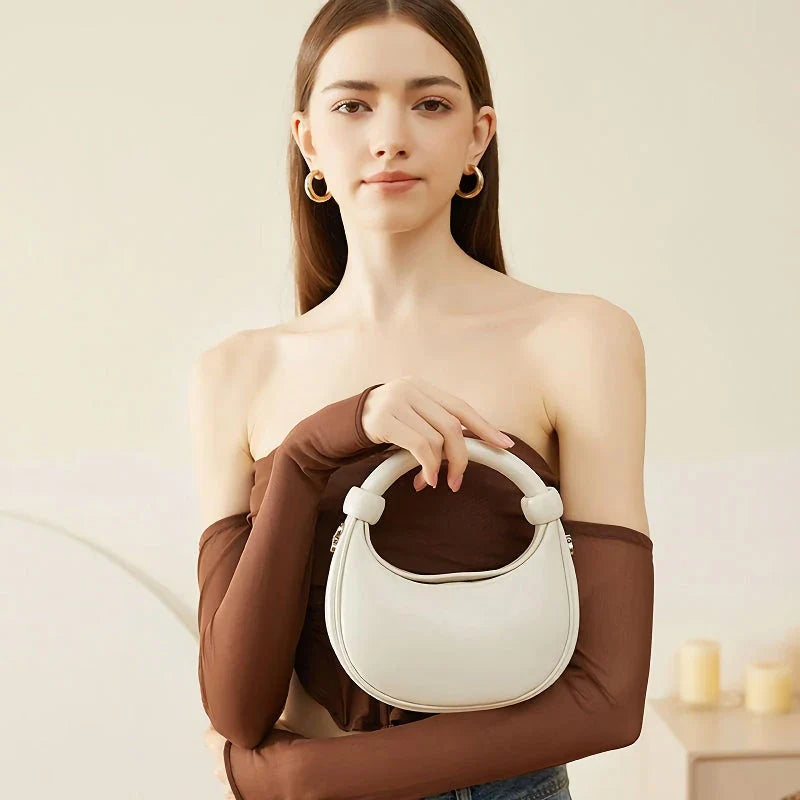 Rose Pink Leather Crescent Crossbody Bag with a unique half-moon design, showcasing premium craftsmanship and versatile functionality