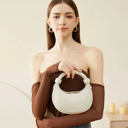 Rose Pink Leather Crescent Crossbody Bag with a unique half-moon design, showcasing premium craftsmanship and versatile functionality