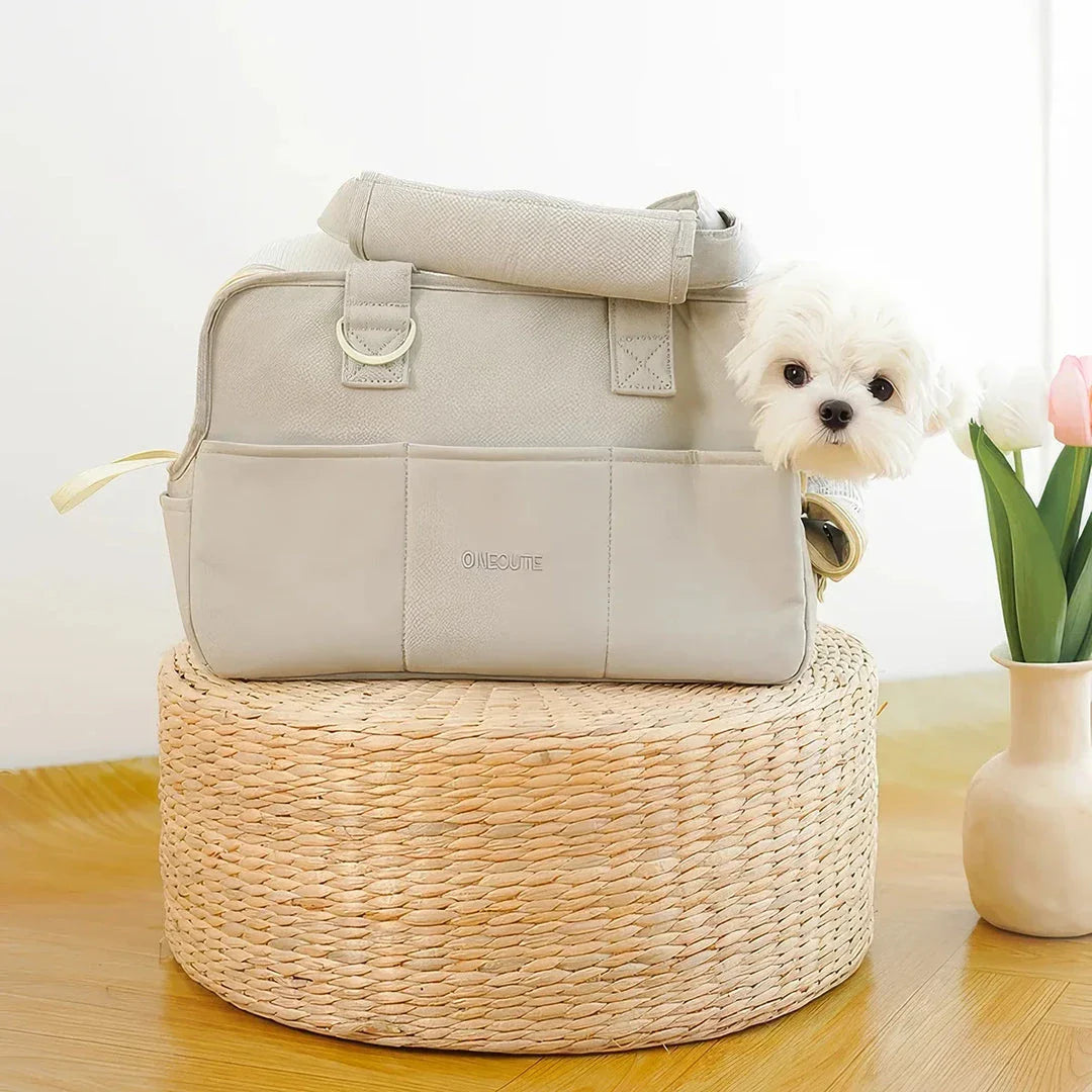 A stylish and practical cotton shoulder bag carrier for small dogs, with a hard board base and cozy interior for comfort and security during adventures.