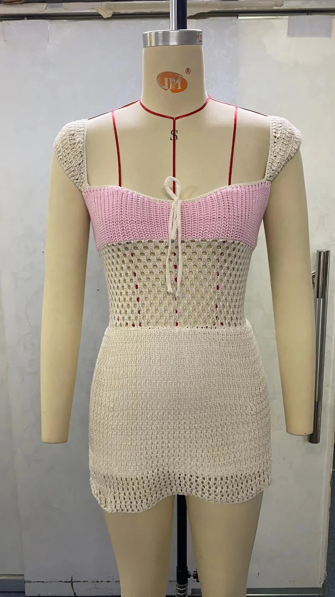 Stylish knitted dress with lace-up detail, available in blue, pink, and brown colors