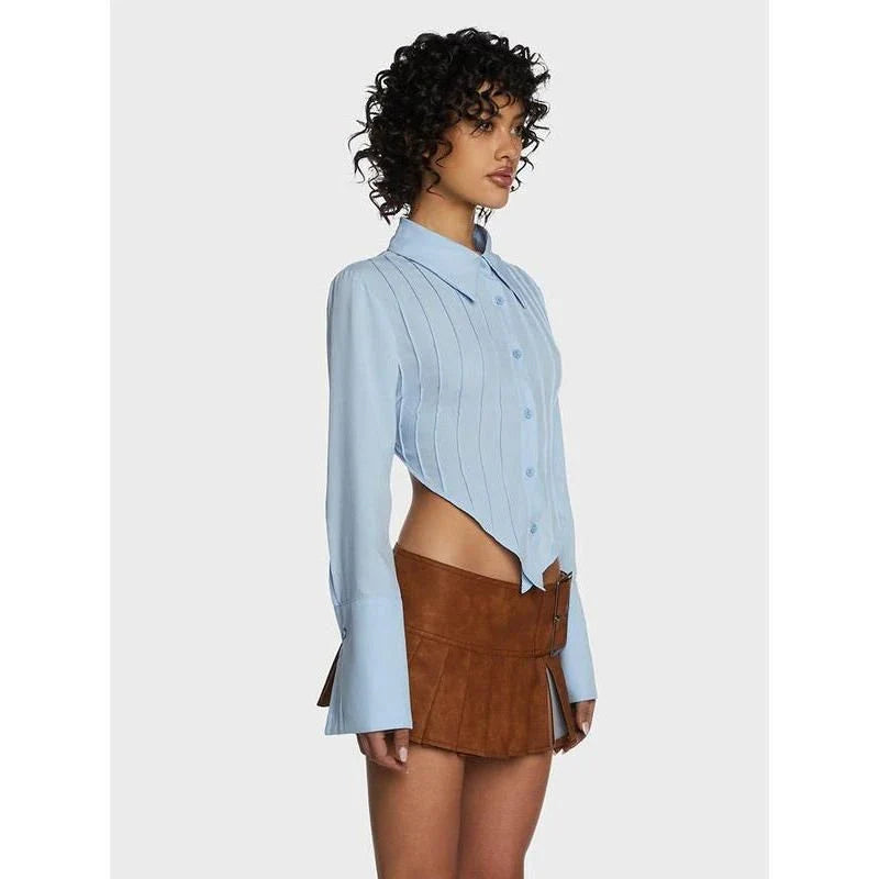 Stylish blue blouse with lace-up back and V-shaped hem, a versatile wardrobe staple with a touch of modern elegance.