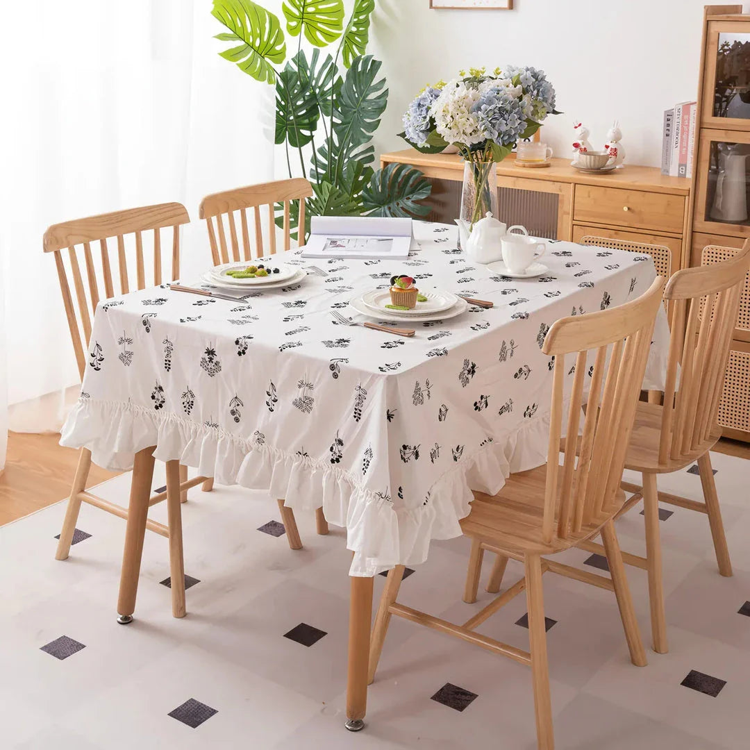 Elegant embroidered floral cotton tablecloth with ruffled edges, perfect for Kiwi homes and hospitality