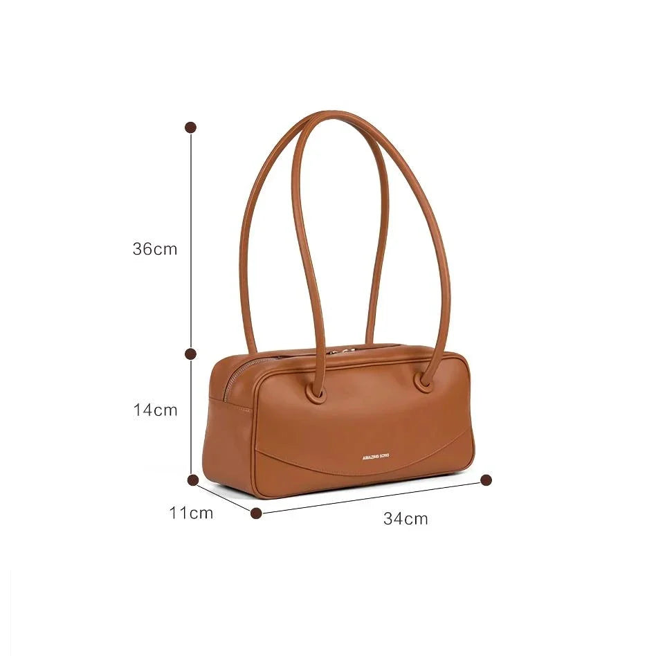 Premium split leather shoulder bag in a baguette shape with a smiley face design, perfect for Kiwis on the go.