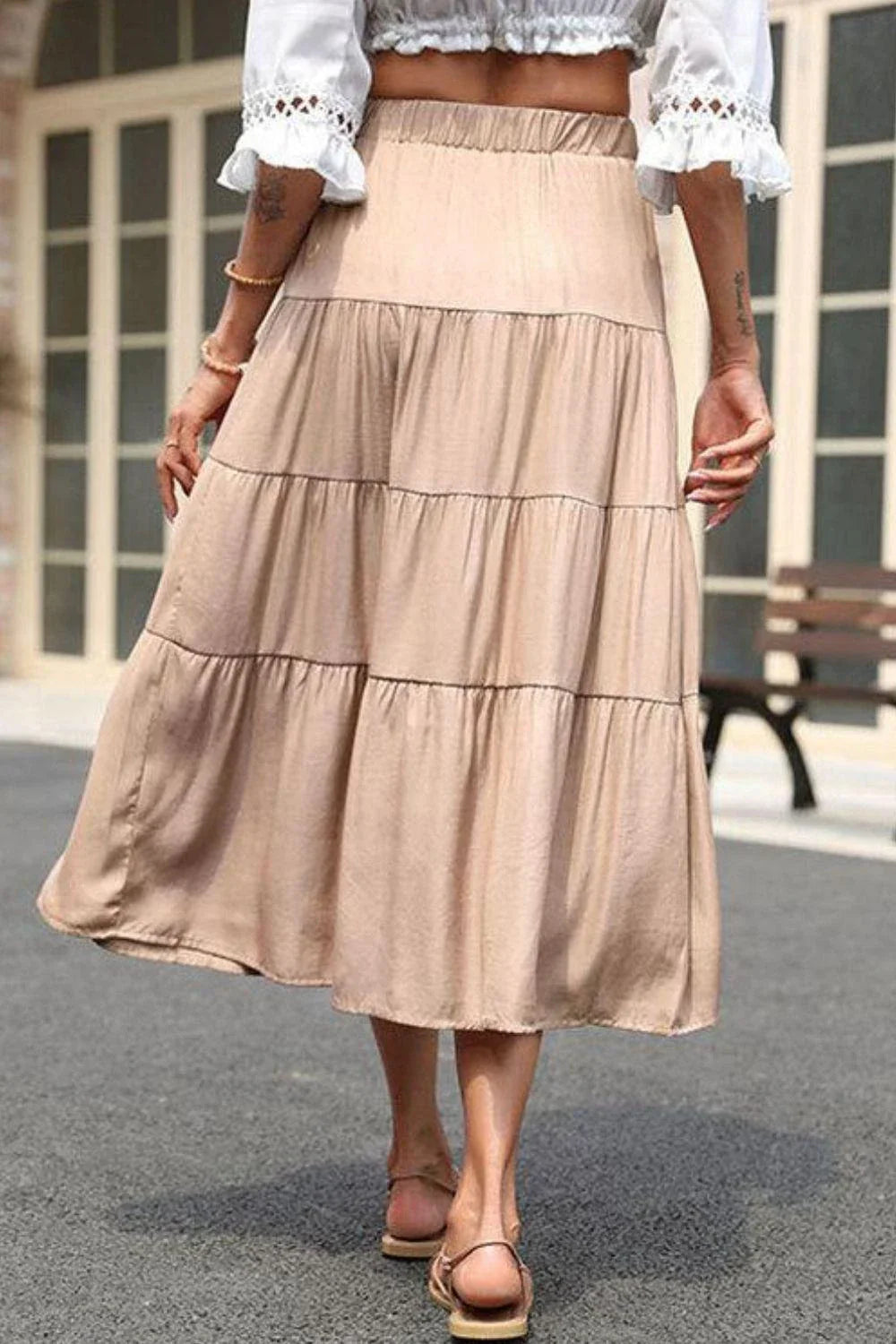 Stylish tiered midi skirt in khaki color with comfortable elastic waistband, made from premium polyester fabric