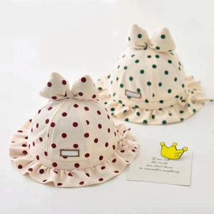 Stylish corduroy baby bucket hat with adorable dot pattern and bow detail, perfect for Kiwi kids