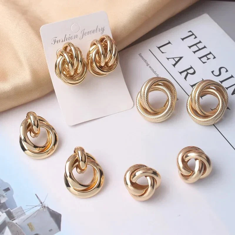 Geometric statement earrings in a luxurious gold finish, featuring a unique hollow twist design for a bold, fashionable look