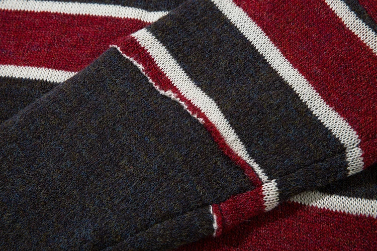 A vibrant red pullover sweater with an eye-catching patchwork stripe pattern, a cozy and stylish Kiwi wardrobe essential.