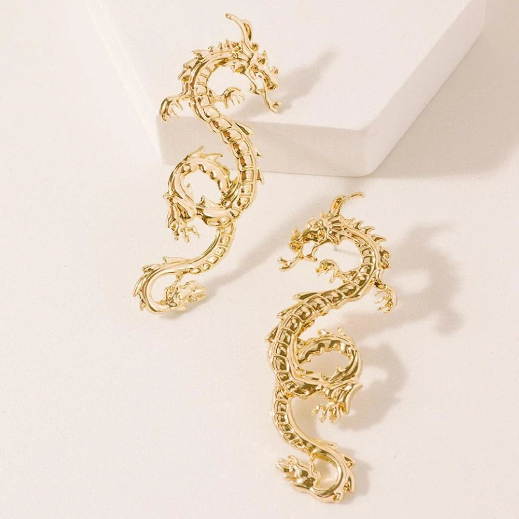 Captivating dragon-shaped stud earrings in gold, a unique New Zealand accessory that adds modern flair to any outfit.