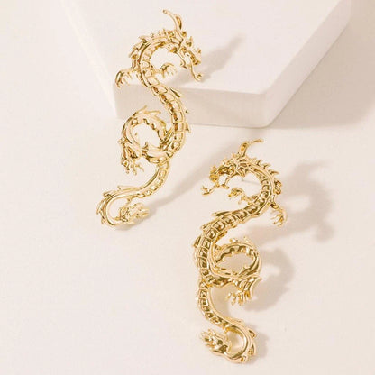 Captivating dragon-shaped stud earrings in gold, a unique New Zealand accessory that adds modern flair to any outfit.