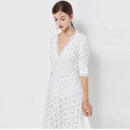 A white lace maxi dress with a stylish V-neck design, perfect for special occasions.