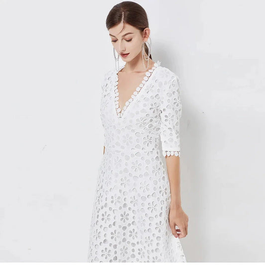 A white lace maxi dress with a stylish V-neck design, perfect for special occasions.