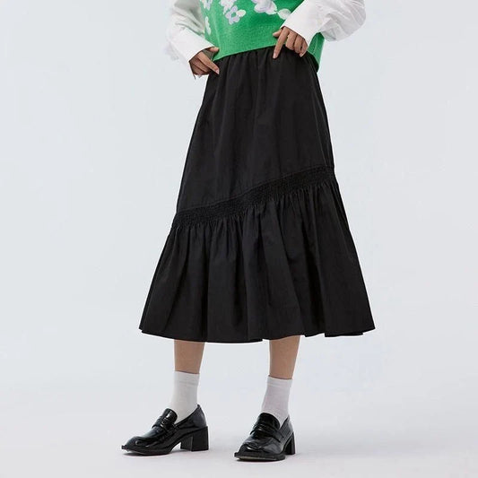 Elegant mid-calf black skirt for women featuring a flattering A-line silhouette and unique irregular hem design