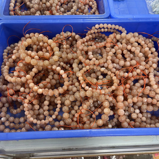 A natural orange moonstone bracelet with a unique sun stone design, inspired by the natural beauty of New Zealand.