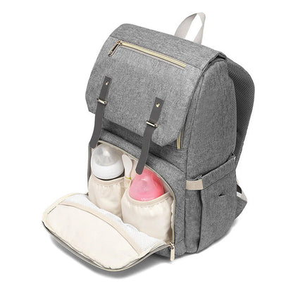 Versatile mum's backpack with pink color, featuring side pockets, zippered compartments, and stroller attachment hooks