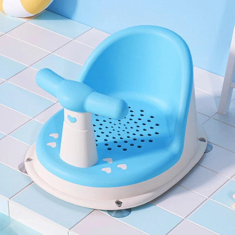 A green, ergonomically designed infant bath tub with large suction cups on the bottom to prevent slipping or tipping.