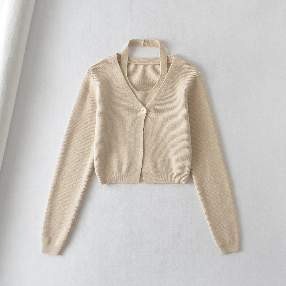 Stylish knitwear vest in a classic black or neutral colour, featuring a V-neck collar and long sleeves for a polished, versatile look.