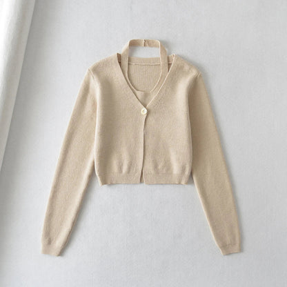 Stylish knitwear vest in a classic black or neutral colour, featuring a V-neck collar and long sleeves for a polished, versatile look.