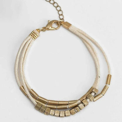 Stylish multilayered bracelet with beige leather and gold-coloured beads, a versatile and modern accessory for Kiwi fashion enthusiasts