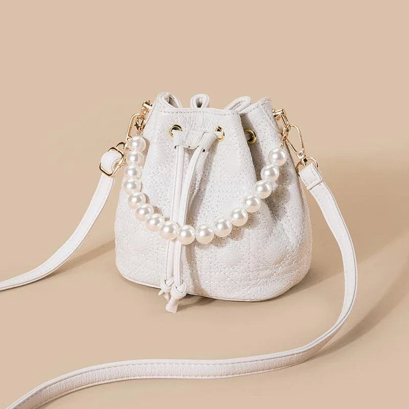 A stylish cowhide bucket handbag in cloud pearl color, featuring a modern design and versatile functionality.