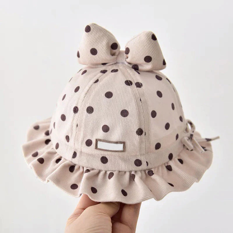 Stylish corduroy baby bucket hat with adorable dot pattern and bow detail, perfect for Kiwi kids