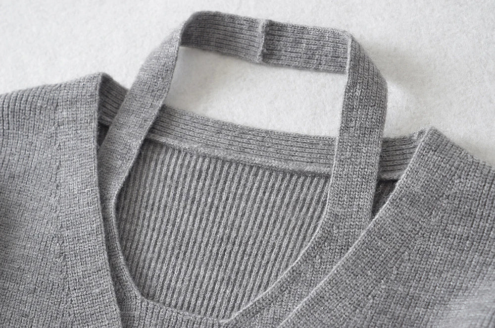 Stylish knitwear vest in a classic black or neutral colour, featuring a V-neck collar and long sleeves for a polished, versatile look.