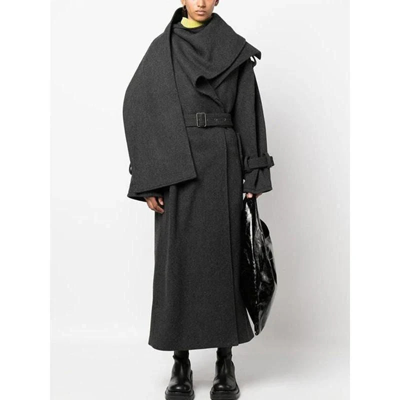 A stylish trench coat with a cosy scarf collar, featuring a patchwork design and adjustable belt for a customised fit.