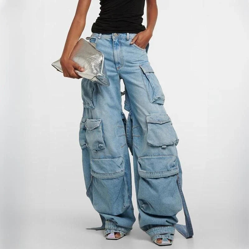 A pair of high-waisted, spliced cargo denim trousers with a distinctive patchwork and hollow-out design