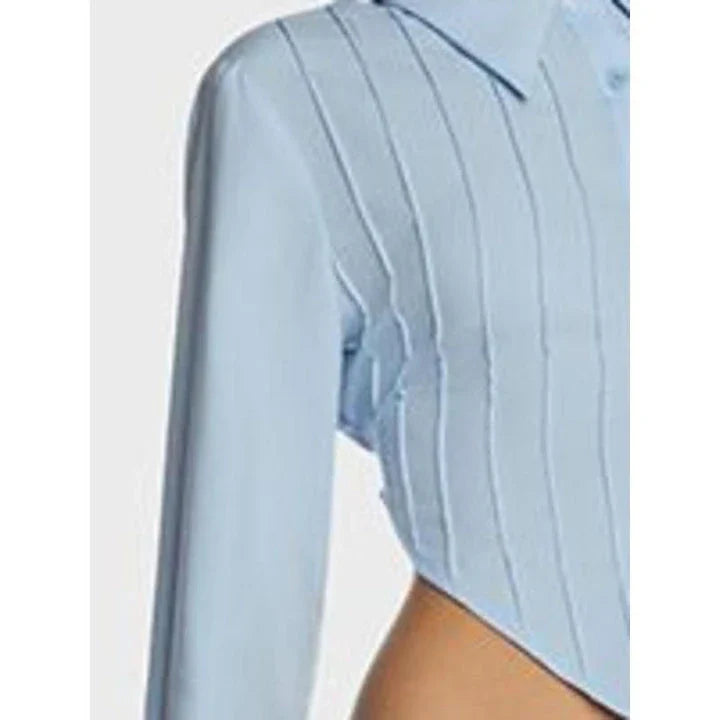 Stylish blue blouse with lace-up back and V-shaped hem, a versatile wardrobe staple with a touch of modern elegance.