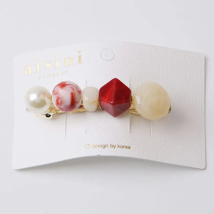 A stylish pearl hair clip with an elegant and sophisticated design, perfect for enhancing the Kiwi fashion aesthetic.