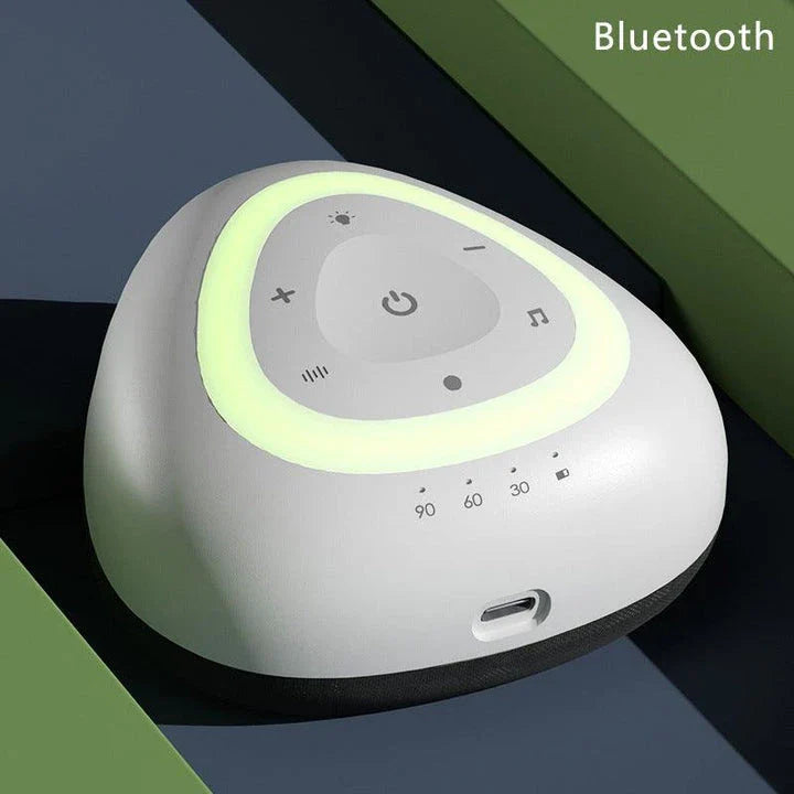 A grey and black white noise machine with ambient lighting, designed to soothe infants and children to sleep