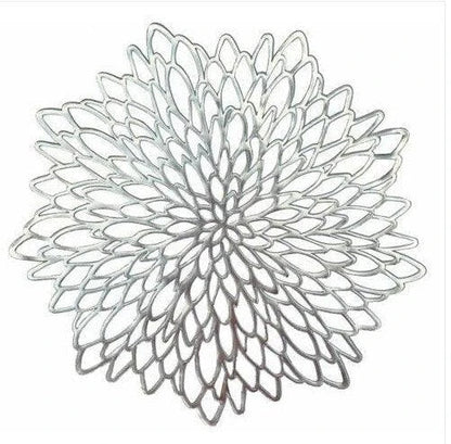 Flower-shaped PVC placemat in gold color, adding natural beauty and elegance to a dining table setting.