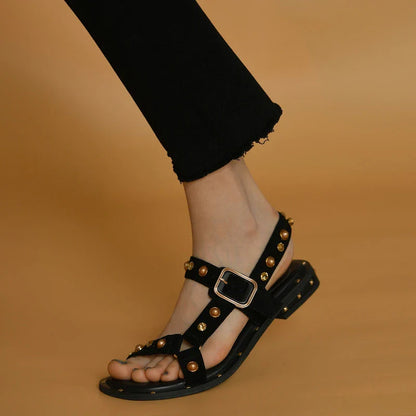 Black flat sandals with orange accents, inspired by the Roman holiday style, perfect for Kiwi women's warm-weather fashion