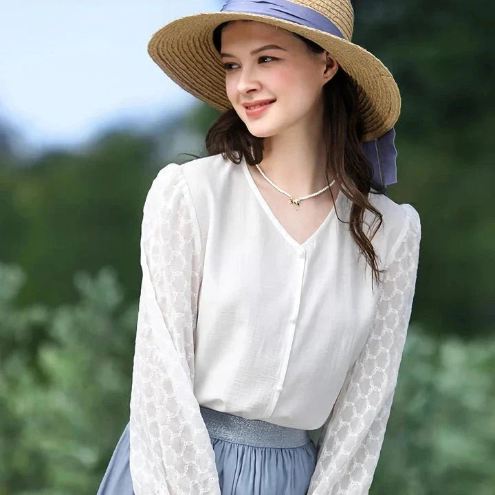 Elegant and versatile French-inspired women's blouse in a classic white color