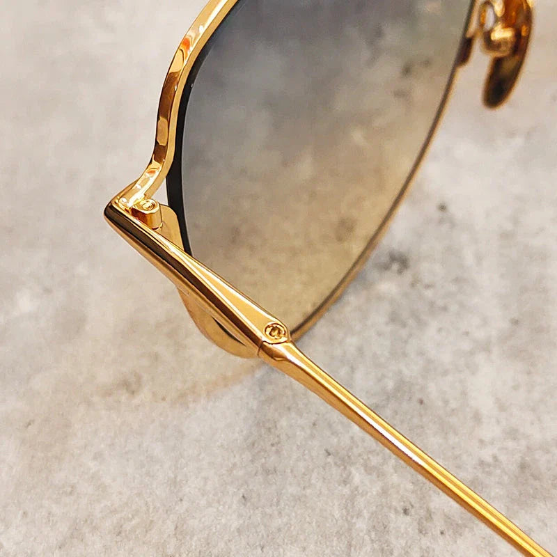 Premium pure titanium pilot sunglasses with a luxurious gold finish, offering superior UV protection and timeless vintage-inspired design.