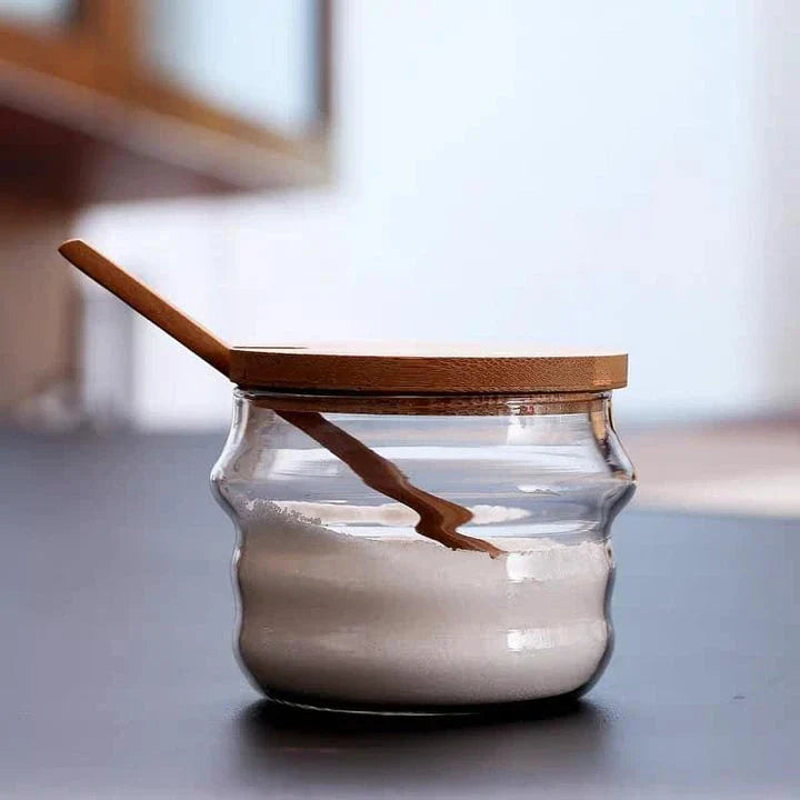 Transparent glass jar with wooden spoon, a versatile and eco-friendly kitchen storage solution for Kiwi homes