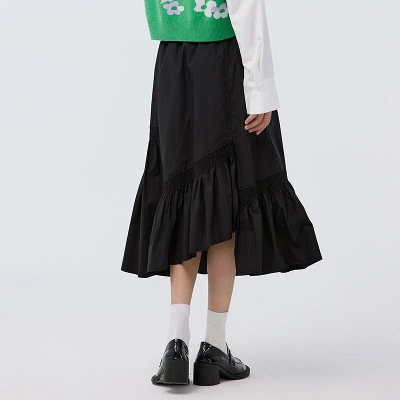 Elegant mid-calf black skirt for women featuring a flattering A-line silhouette and unique irregular hem design