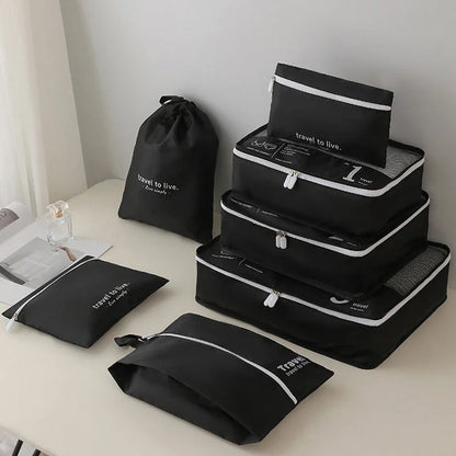 Seven-piece travel organiser set in black with various sized bags for efficient packing and suitcase organisation