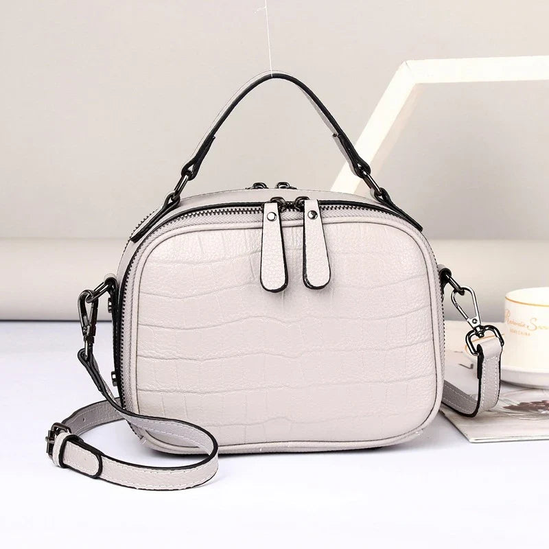 Stylish first layer leather crossbody bag in offwhite color, featuring a trendy square design and multiple interior pockets for Kiwi fashionistas