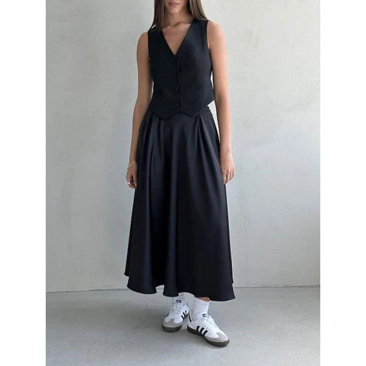 Elegant black satin maxi skirt with flattering empire waistline and ankle-length A-line silhouette, suitable for both formal and casual wear.