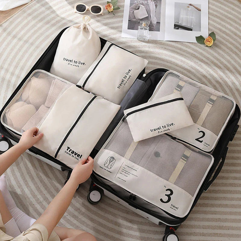 Seven-piece travel organiser set in black with various sized bags for efficient packing and suitcase organisation