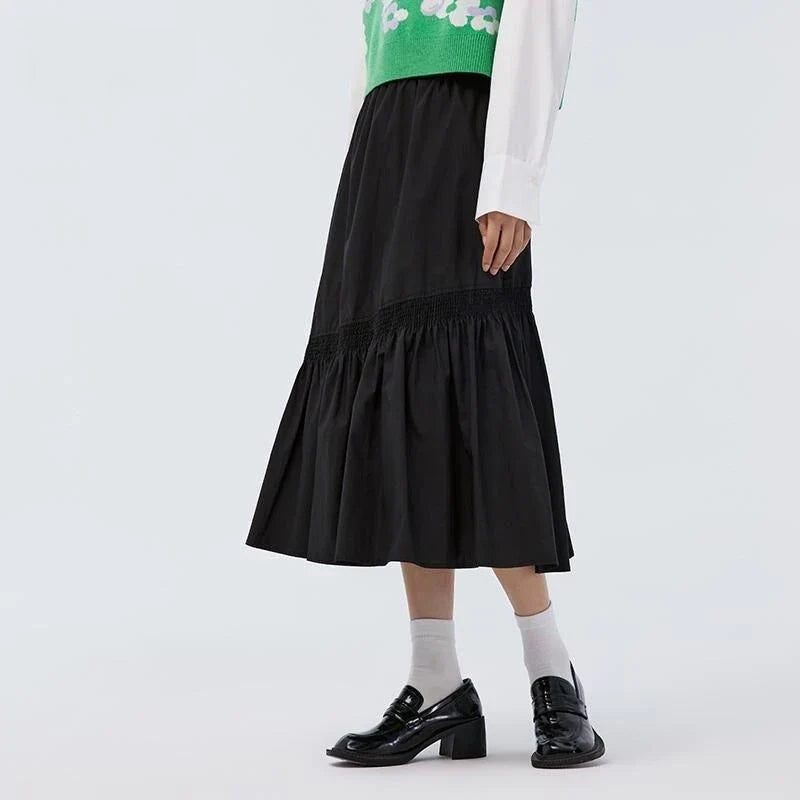 Elegant mid-calf black skirt for women featuring a flattering A-line silhouette and unique irregular hem design