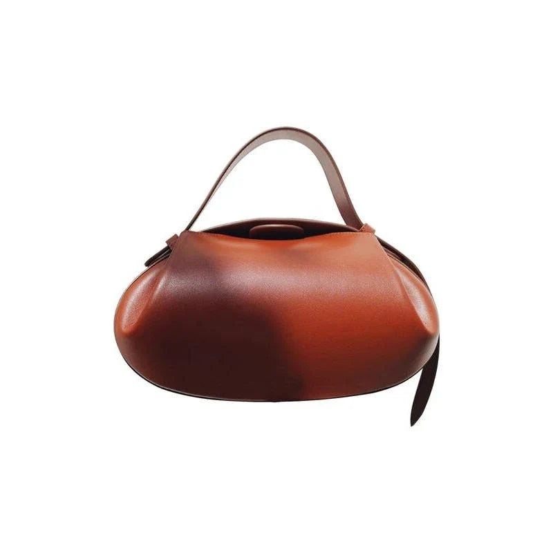 A stylish circular vegan leather handbag with a unique rugby-inspired design, perfect for Kiwi fashion enthusiasts