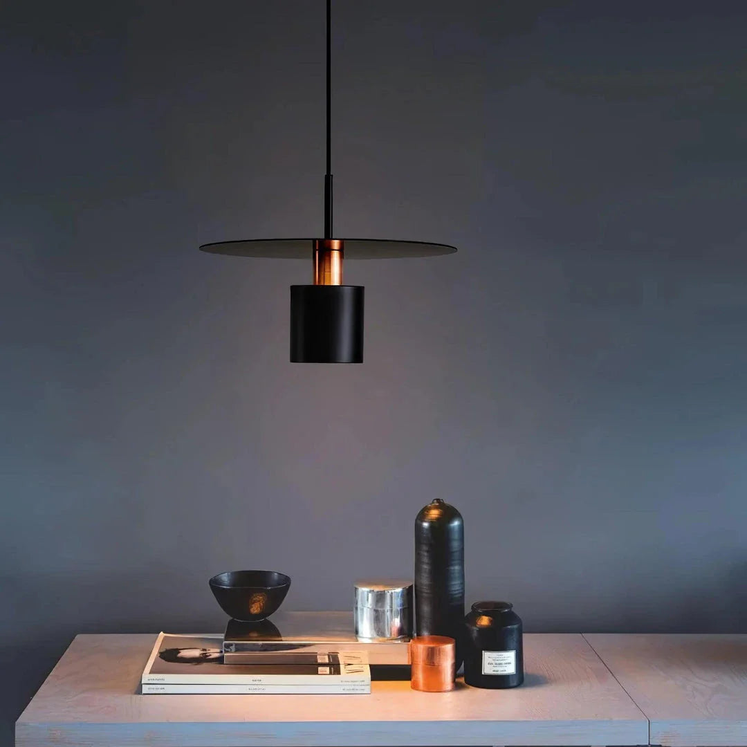 A modern, minimalist pendant light with a sleek, painted metal design, perfect for enhancing the ambiance of cafes, bedrooms, and other contemporary interior spaces.