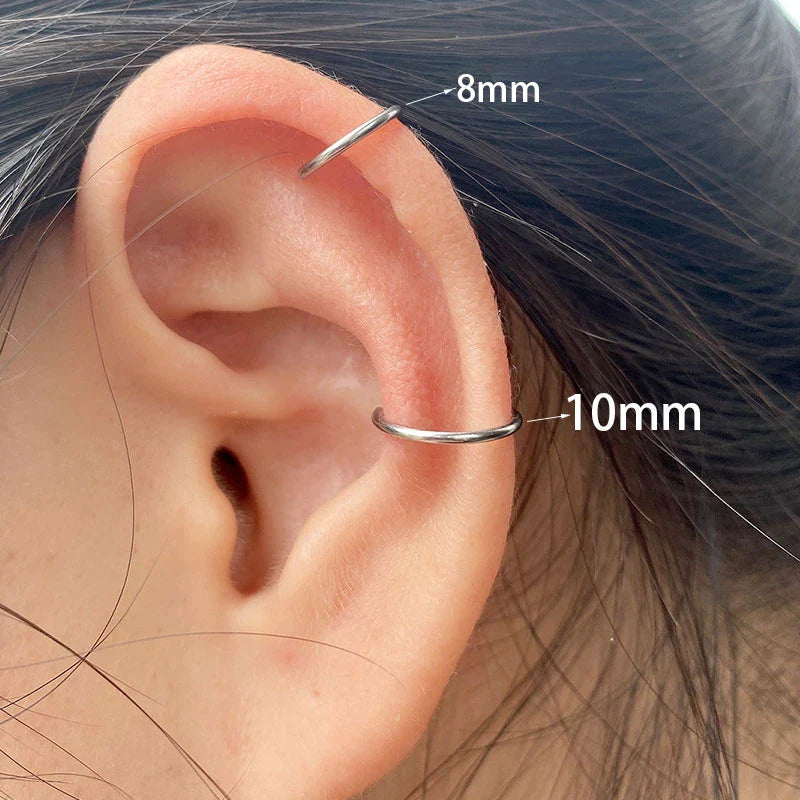 Stylish titanium steel lip rings in gold, silver, and black colors, featuring a unique cuff-style design for a bold, free-spirited look.